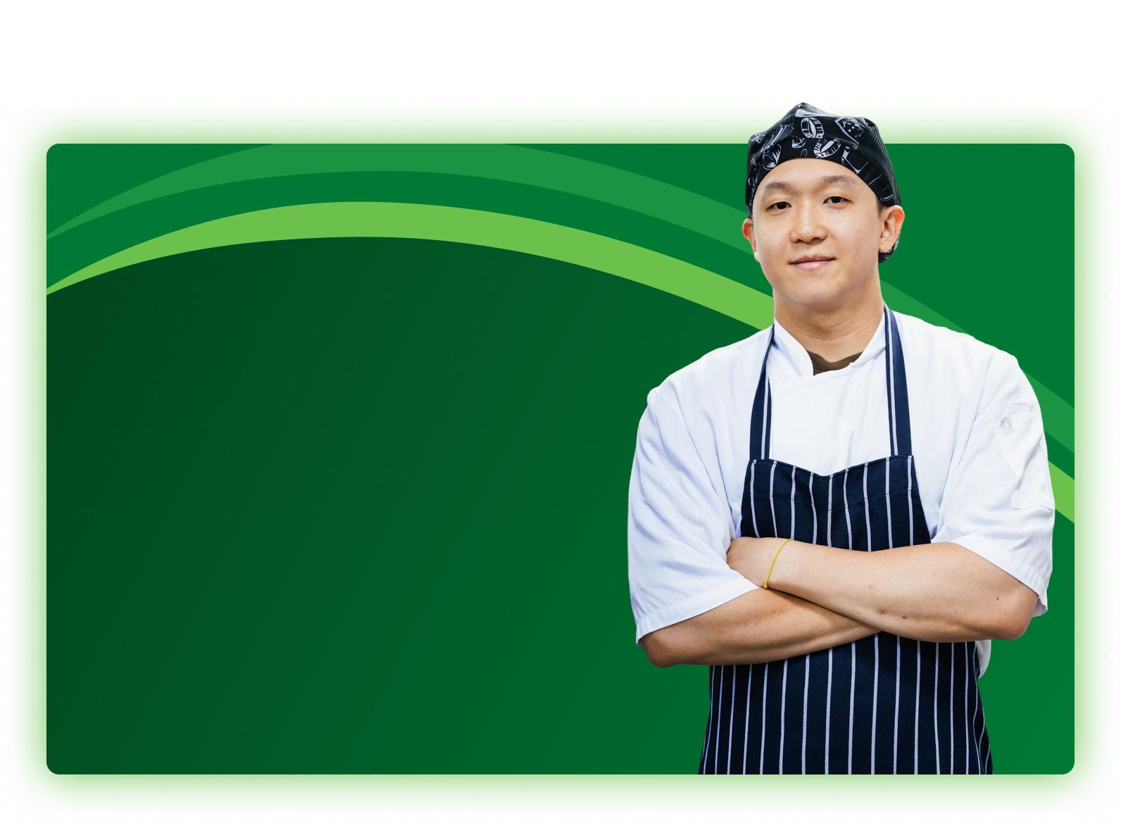 Smiling chef with arms crossed in a white jacket, patterned bandana and navy striped apron