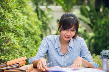 Asian woman working on desk outdoor.