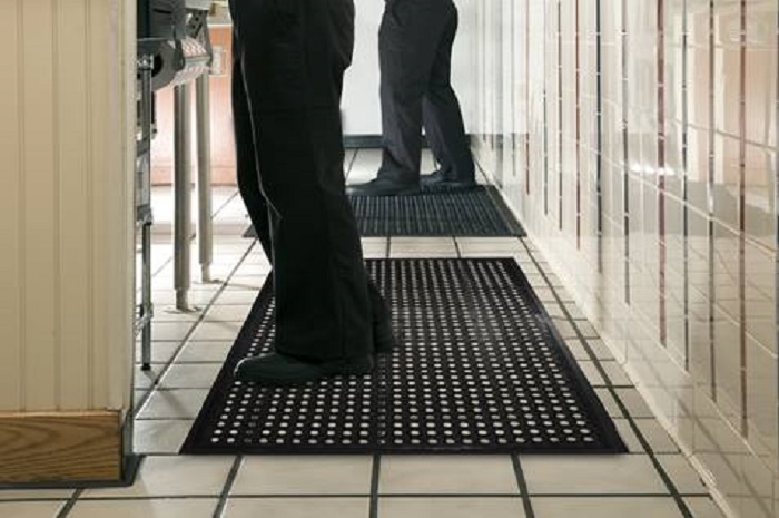 Working while standing using anti-fatigue mats.