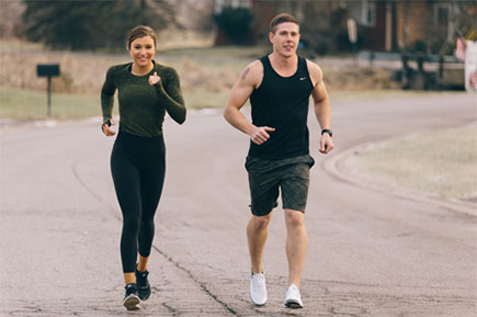 A man and a woman jogging after work.