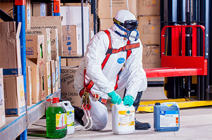 A man wearing a safety overall uniform at work.