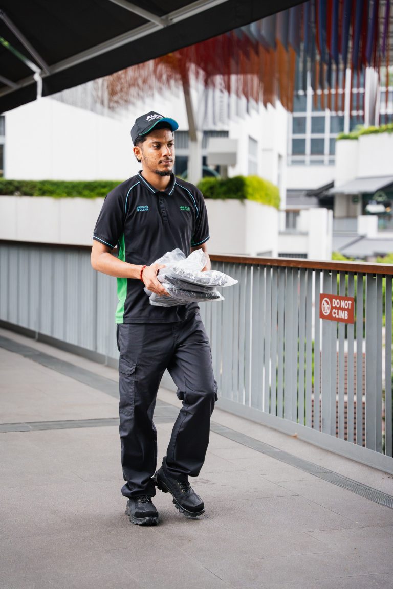 Alsco Singapore uniform laundering process with industrial washing machines at full capacity
