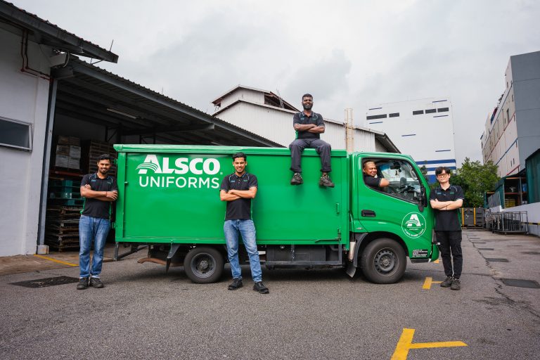 Alsco Singapore uniform processing line with garments moving through industrial dryers