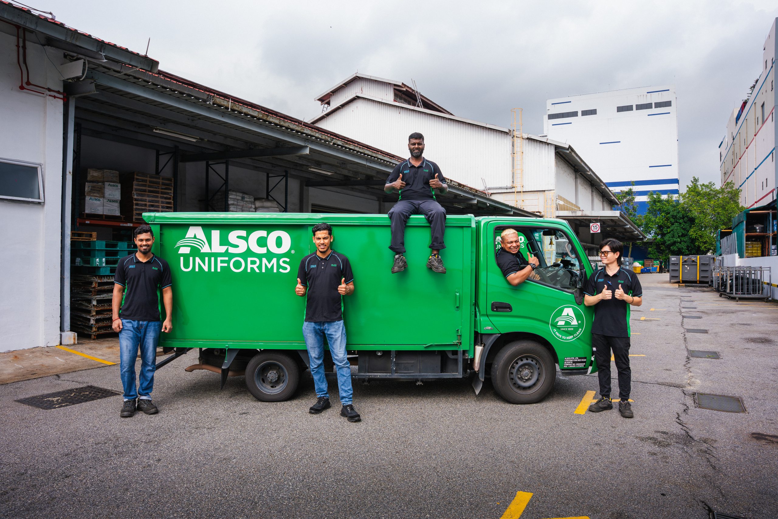 Alsco Uniforms Singapore service team with an Alsco delivery truck