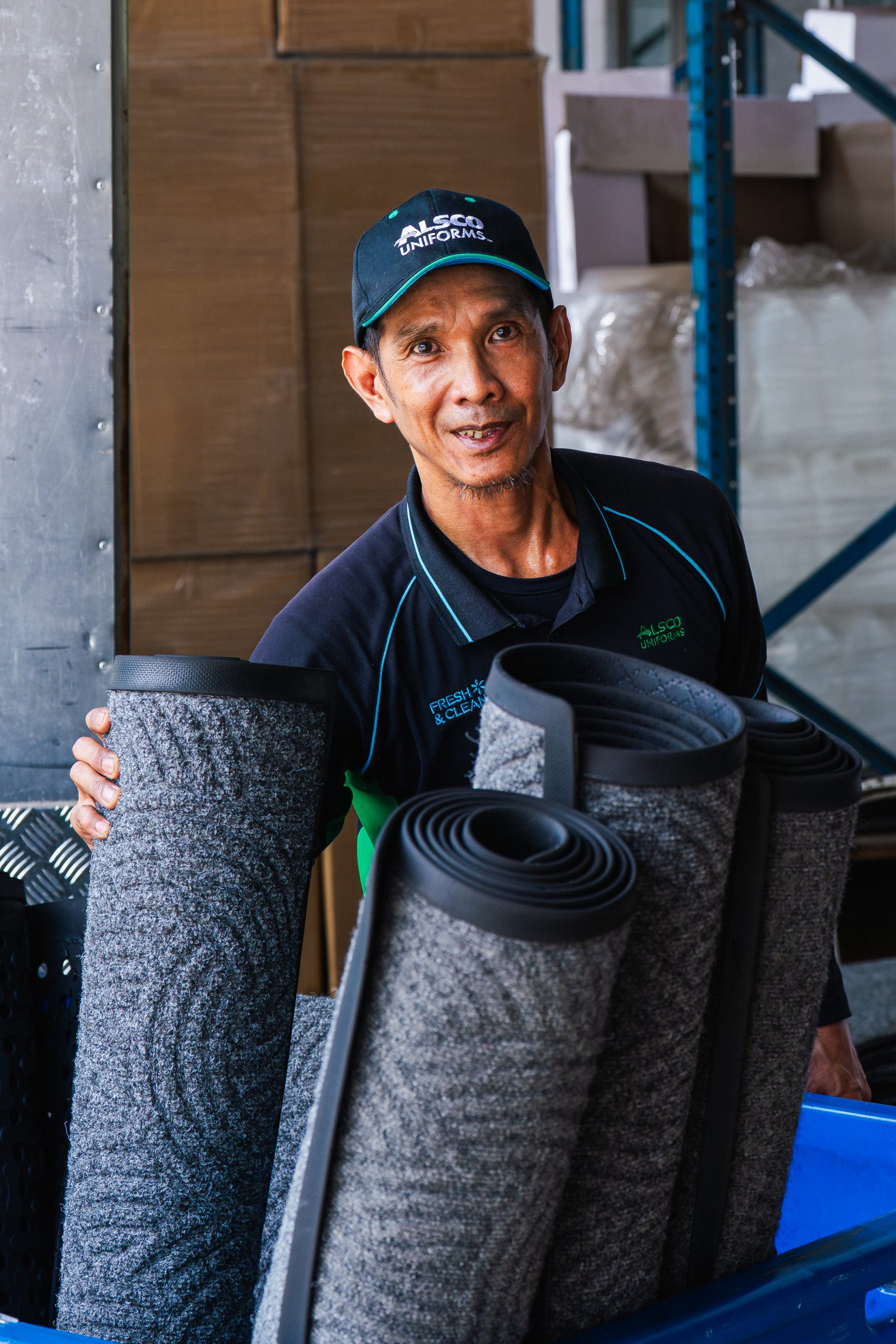 Alsco Singapore industrial laundry machine processing commercial uniforms at the Singapore facility
