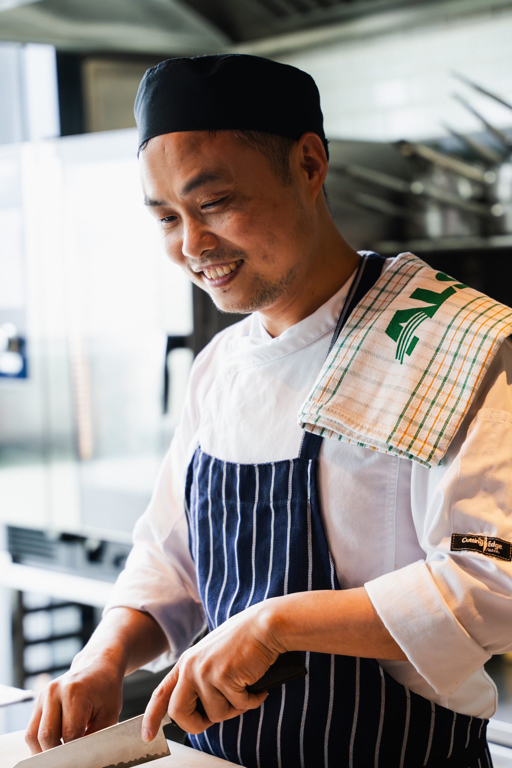 Chef wearing Alsco premium chefswear and holding a linen towel