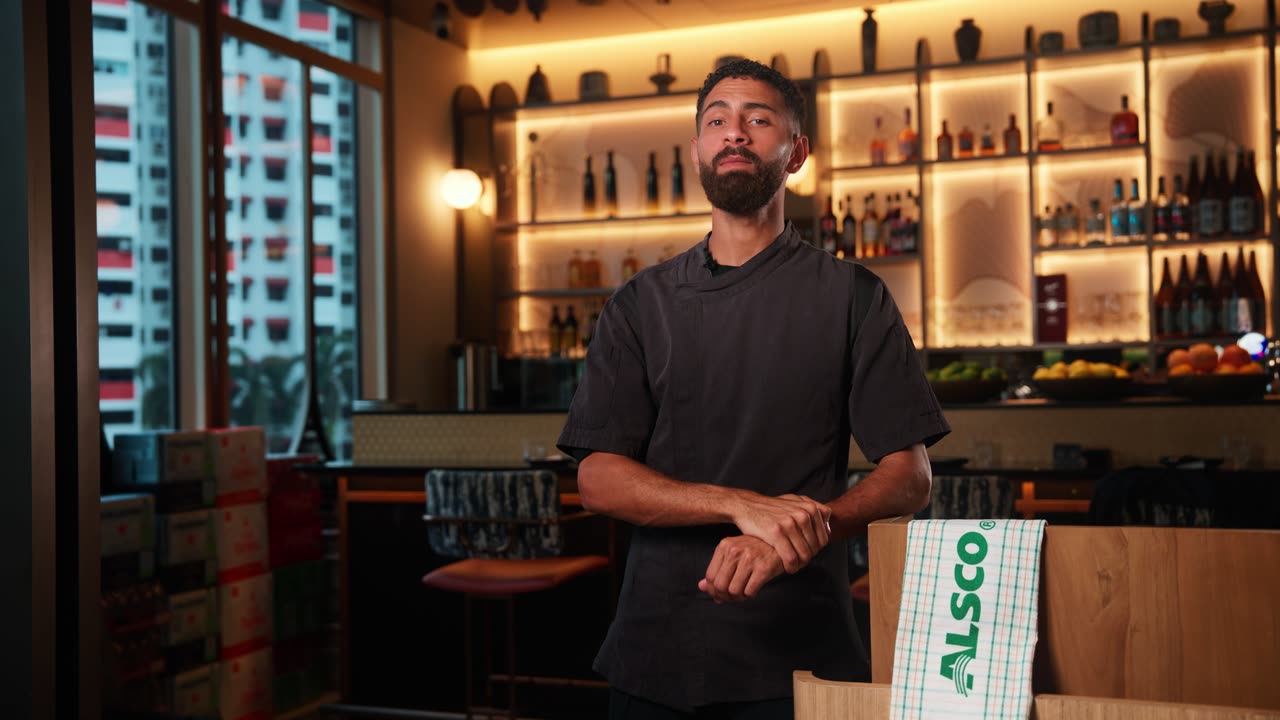 Youssef, chef at Ginkyo by Kinki, in his restaurant with an Alsco kitchen towel, video testimonial for Alsco Uniforms Singapore