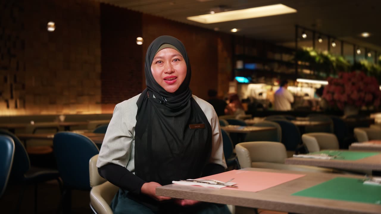 Salma, Supervisor at The Marmalade Pantry, in the restaurant dining room, video testimonial for Alsco Uniforms Singapore