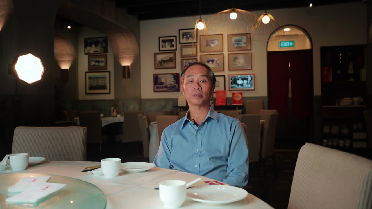 Joseph, Senior Manager at Spring Court Restaurant, in the restaurant dining room, video testimonial for Alsco Uniforms Singapore